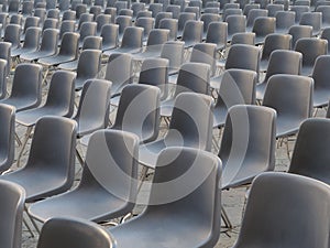 Vavant or empty plasti grey chairs outdoor arranged for event or performance