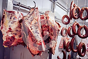 Veal meat carcass and Turkish sausage in the cold storage room