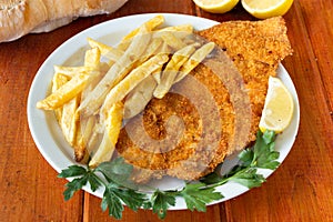 Veal milanesa with frenchc fries photo