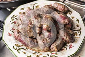 Veal rolls with bacon, cheese and plum