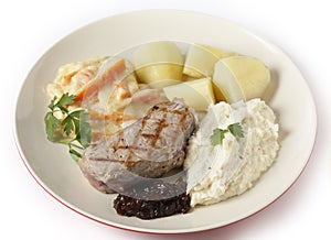 Veal steak with gourmet vegetables side view