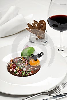 Veal tartar and wine in a restaurant