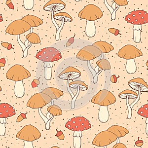 Vector autumn seamless pattern with amanita and cap mushrooms and acorns on the beige dotted background. Vintage ornament
