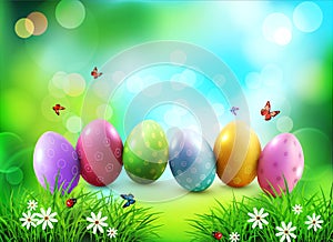 Vector background. Easter eggs in green grass with white flowers