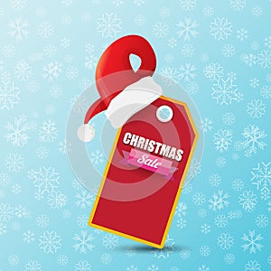 Vector Christmas sales paper banner or tag label with red santa hat on snowy blue background with falling snowflakes