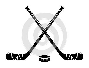 Vector crossed hockey sticks and hockey puck photo