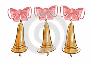 Set of gold metal bells with pink bows. Symbol of Christmas