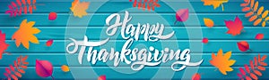 Vector Hand drawn Happy Thanksgiving typography poster with fallen leaves on wood turquoise background