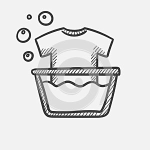 T-shirt in basin with foam hand drawn sketch icon.