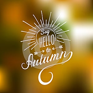 Vector hand lettering inspirational typography poster Say Hello to autumn with rays.