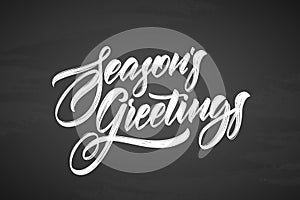 Vector illustration. Handwritten calligraphic brush txtured lettering of Seasons Greetings on chalkboard background