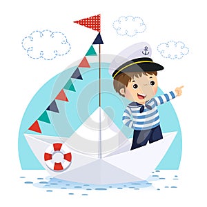 Little boy in sailor costume standing in a paper boat photo