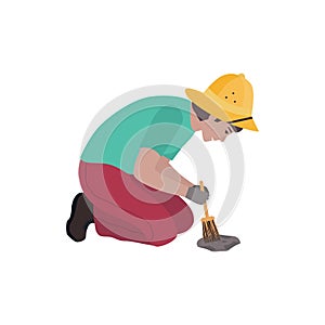 Vector illustration with a male archaeologist who sweeps the earth with a brush with a rare find.