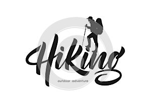 Vector illustration: Modern brush lettering of Hiking with silhouette of climber