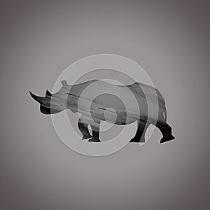 Vector illustration of a silhouette of a rhino standing on gray background. Rhinoceros side view profile. Figure