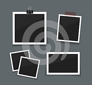 Vector photo frames sticked with tape and hanged on paper clip. Retro fotos. Dark background. photo