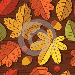 Vector seamless colorful pattern of autumn leaves over wooden texture background.
