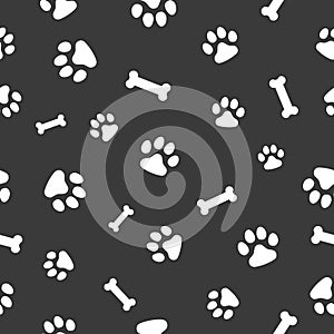 Vector, seamless pattern. Abstraction,, white traces of paws of a cat, dog, bones on a dark gray background. For prints, packaging photo