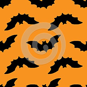Vector seamless pattern of a black bat silhouette on an orange background for a Halloween packaging design template and background