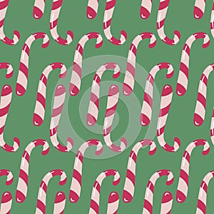 Vector seamless pattern with candycanes on green background