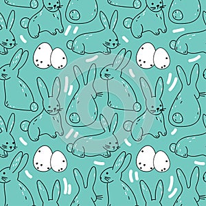 Vector seamless pattern with cute rabbits and eggs on a blue background