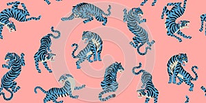 Vector seamless pattern with cute tigers on the pink background. Fashionable fabric design.