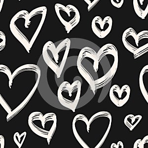 Vector seamless pattern with hand drawn hearts. Simple black and white texture