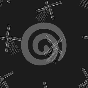 Vector seamless pattern of a white silhouette of mills on a black background.