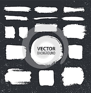 Vector set of brush ink strokes. White on black background