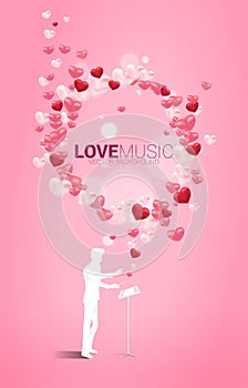 Vector silhouette of conductor standing with piano key with heart balloon flying .