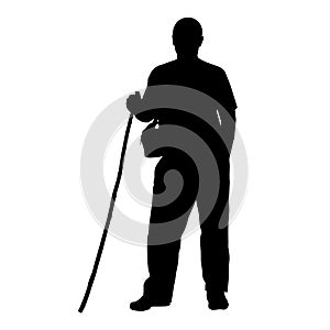 Vector silhouette of a man with a cane on a white background.