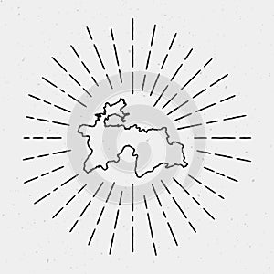 Vector Tajikistan map outline with retro sunburst.