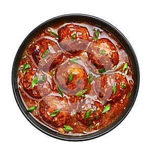 Veg Manchurian Gravy Balls in black bowl isolated on white. Vegetarian Manchurian is indian chinese cuisine dish