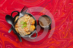 Veg Schezwan Hakka Noodles served in a Black colored bowl with Manchow soup