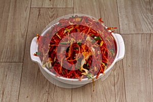 veg schezwan noodles in bowl on wooden background