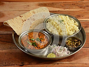 Veg Thali from an indian cuisine, food platter consists variety of veggies, jeera rice, roti, dal makhani etc., selective focus