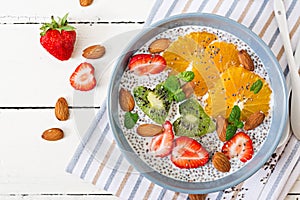 Vegan almond milk chia seeds pudding with strawberries, orange and kiwi