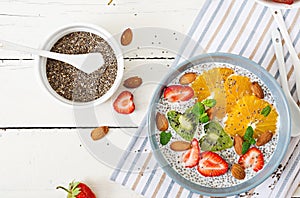 Vegan almond milk chia seeds pudding with strawberries, orange and kiwi