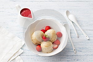 Vegan banana ice cream with strawberry sauce and fresh strawberries