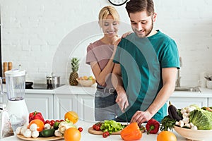 vegan boyfriend cutting vegetables
