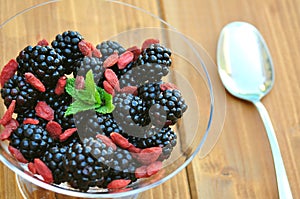 Vegan breakfast with goji berries and blackberries