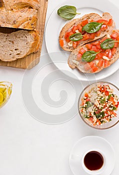 vegan breakfast of sandwiches with tomato, taboule bulgur salad and coffee on a white background.