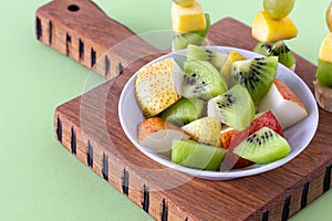 Vegan breakfast. variety of fruits on wooden cutting board  selective focus  fruit salad