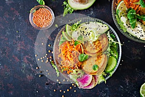 Vegan buddha bowl dinner food table. Healthy food. Healthy vegan lunch bowl. Fritter with lentils and radish, avocado, carrot sala