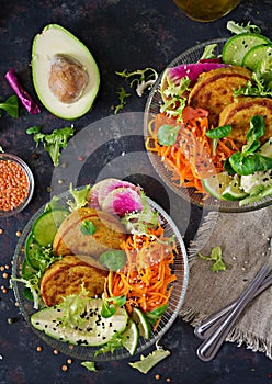 Vegan buddha bowl dinner food table. Healthy food. Healthy vegan lunch bowl. Fritter with lentils and radish, avocado, carrot sala