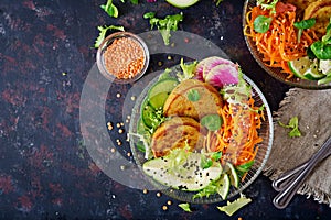 Vegan buddha bowl dinner food table. Healthy food. Healthy vegan lunch bowl. Fritter with lentils and radish, avocado, carrot sala