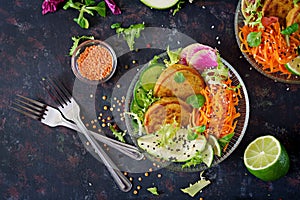 Vegan buddha bowl dinner food table. Healthy food. Healthy vegan lunch bowl. Fritter with lentils and radish, avocado, carrot sala