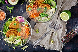 Vegan buddha bowl dinner food table. Healthy food. Healthy vegan lunch bowl. Fritter with lentils and radish, avocado, carrot sala