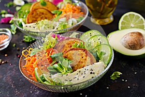 Vegan buddha bowl dinner food table. Healthy vegan lunch bowl. Fritter with lentils and radish, avocado, carrot salad.