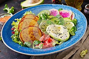 Vegan buddha bowl dinner food table. Healthy vegan lunch bowl. Fritter with lentils and radish, avocado salad